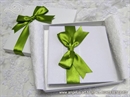 white hardcover greeting card with green bow