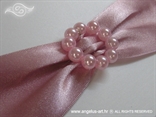 pink beads brooch on a wedding invitation